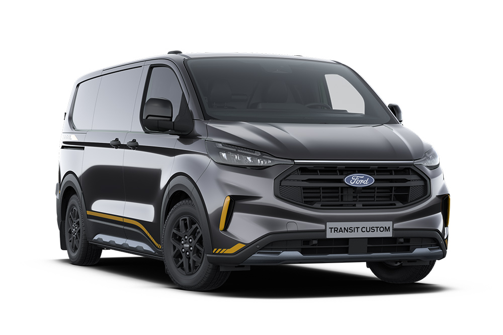 Egy sötétszürke Trail Ford Transit Custom, aranyszínű dekorcsíkokkal.