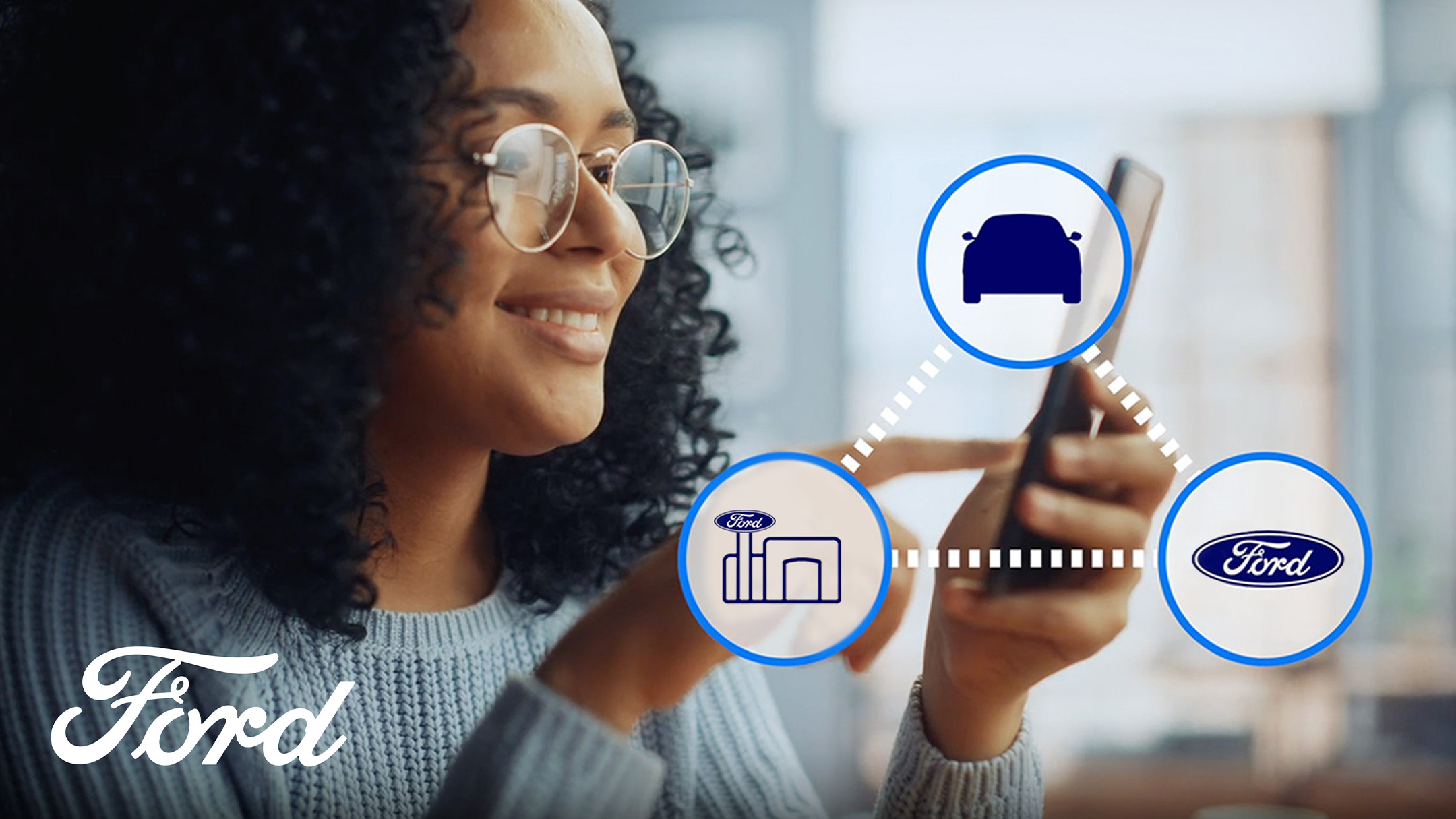 A close up of a hand holding a smartphone and interacting with the Ford app